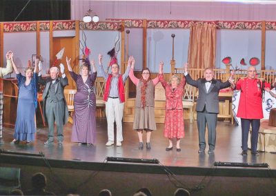 Close up of cast members holding hands for final bow on stage - Heart of the Hills Players Something's Afoot Performance 2018